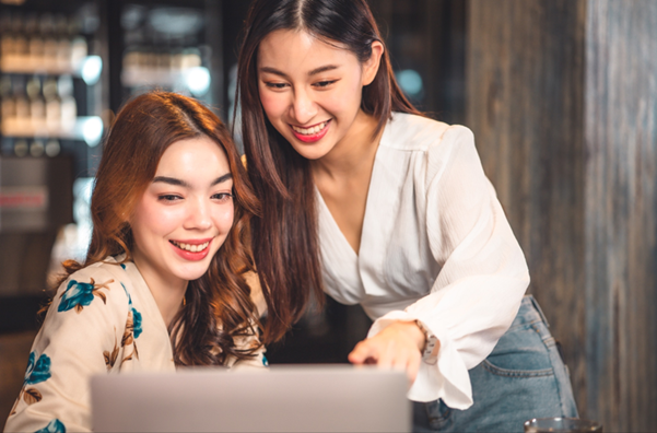 Two happy customers looking at their affordable website