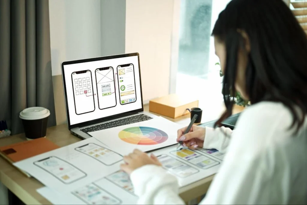 Professional Web Design and UX Planning Web designer creating UI and UX layouts on a laptop for a professional website redesign