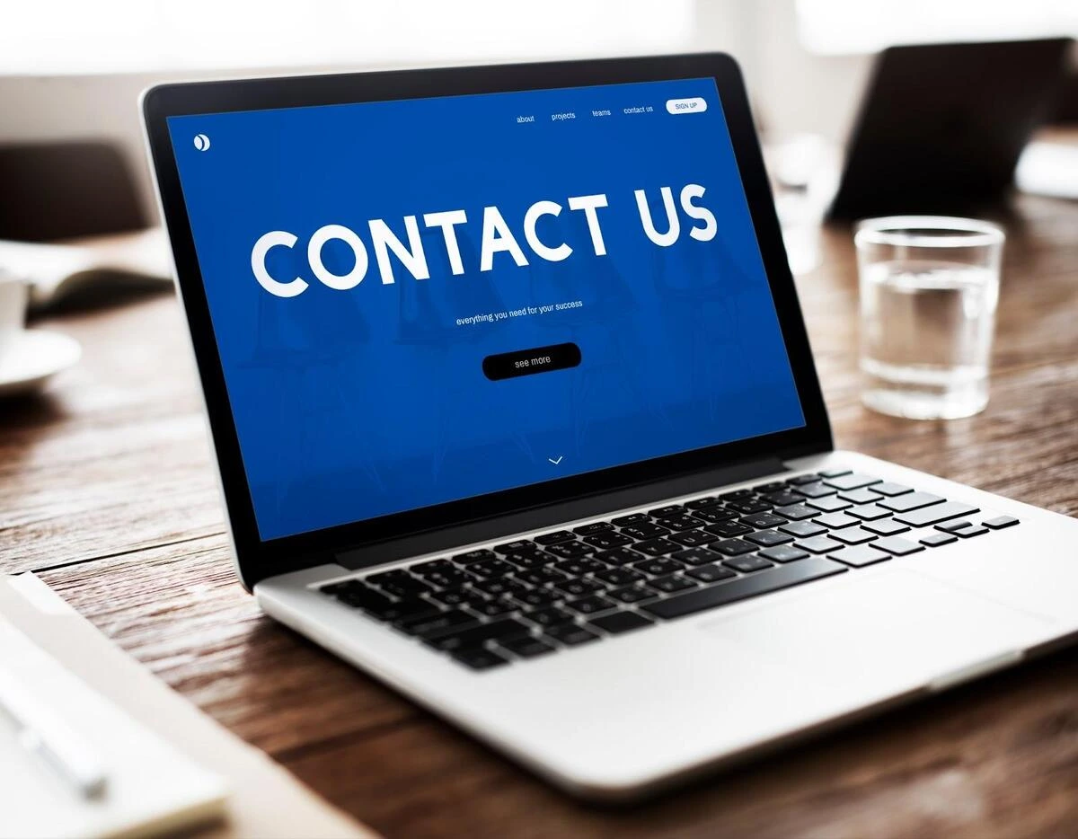 Laptop displaying a Contact Us webpage on screen, representing an essential contact page for small business websites