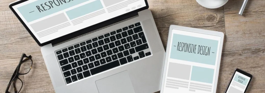Laptop, tablet, and smartphone displaying a responsive website design layout